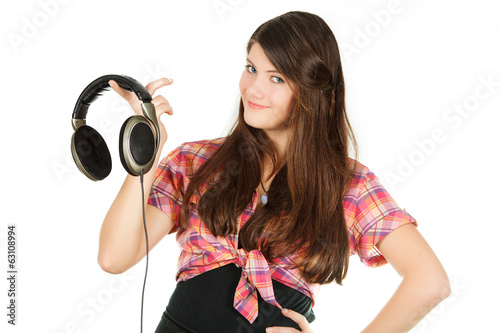 a smiling happy girl holds headsets in a hand