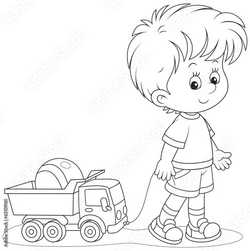Little boy with a toy truck and ball