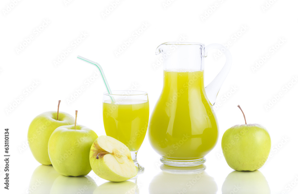 Fresh green apples, glass with juice and carafe
