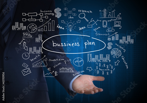 Man in suit holding business plan