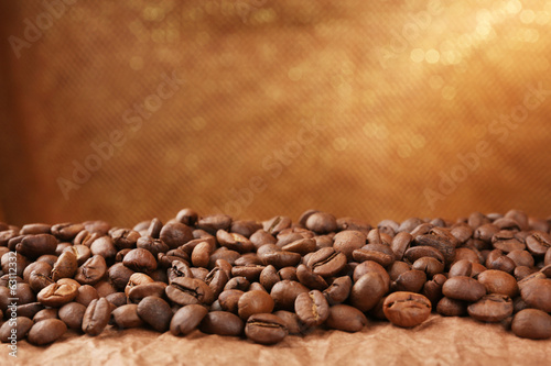 Coffee beans on table on brown background © Africa Studio