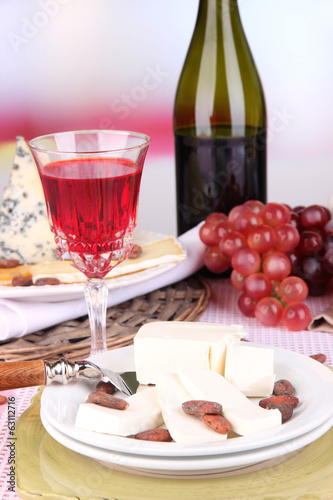 Assorted cheese plate , grape and wine glass
