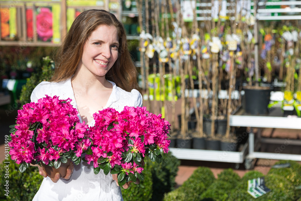 Customer at garden center or flower shop posing with flowers
