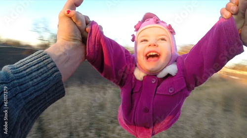 Slow Motion. Man Rotates His Little Daughter Outdoor, First Pers