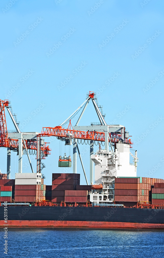 Naklejka premium Container stack and ship under crane bridge