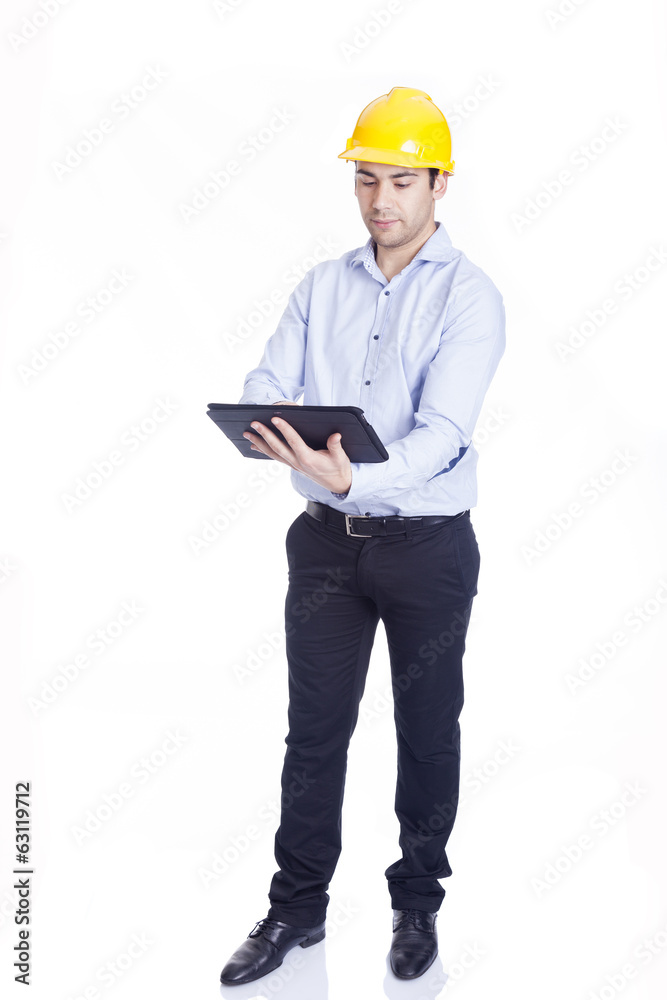 Handsome engineer working with a tablet pc, isolated on white Handsome engineer working with a tablet pc, isolated on white