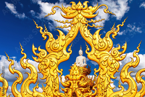 Buddha statue against a blue sky with clouds. Chiang Rai.
