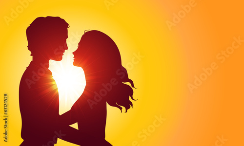 Sunset silhouettes of kissing couple