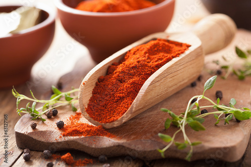 Fotografie, Obraz red ground paprika spice in wooden scoop and bowl