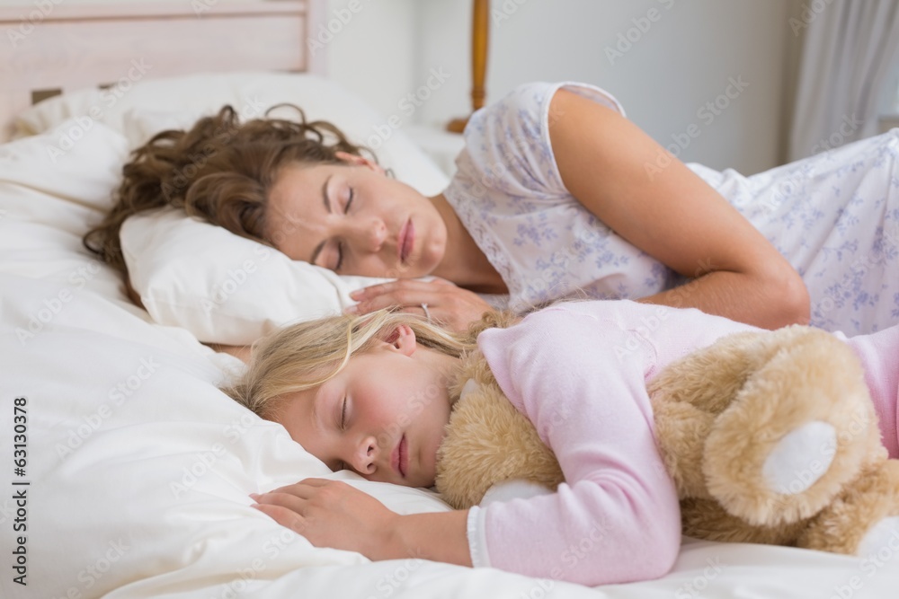 Girl and mother sleeping with stuffed toy in bed Girl and mother sleeping with stuffed toy in bed