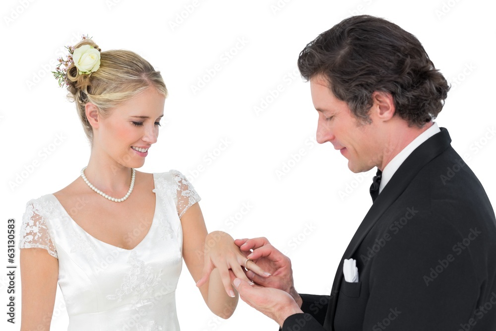 Attractive bride and groom exchanging wedding ring Attractive bride and groom exchanging wedding ring