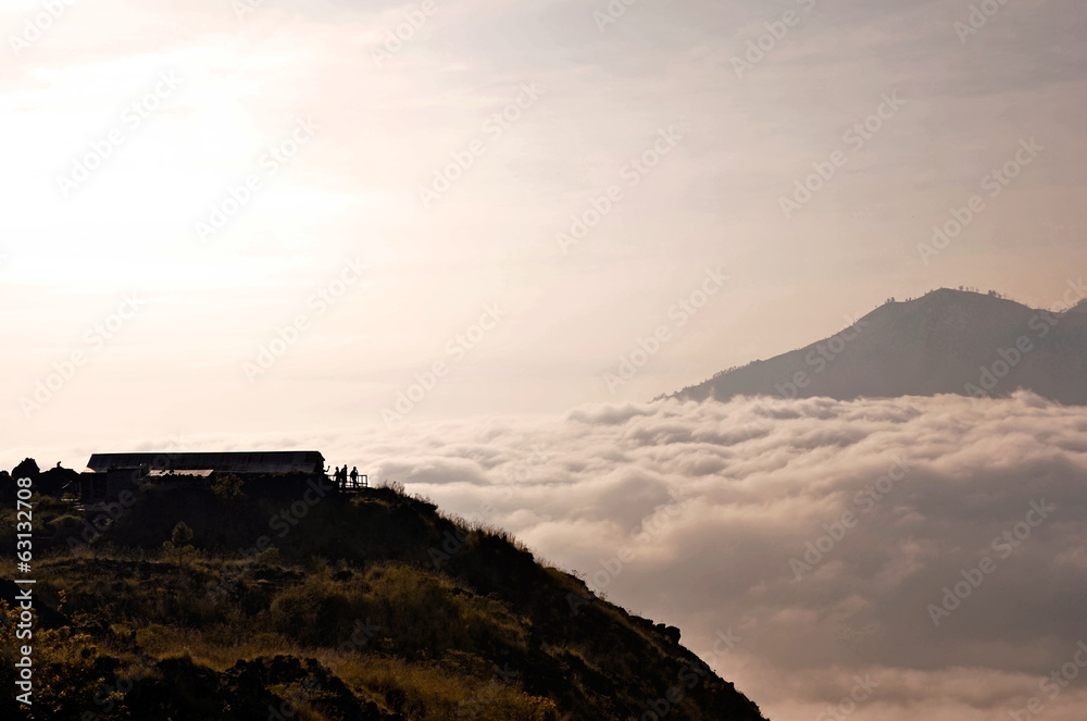 Above clouds with a mountain volcano view