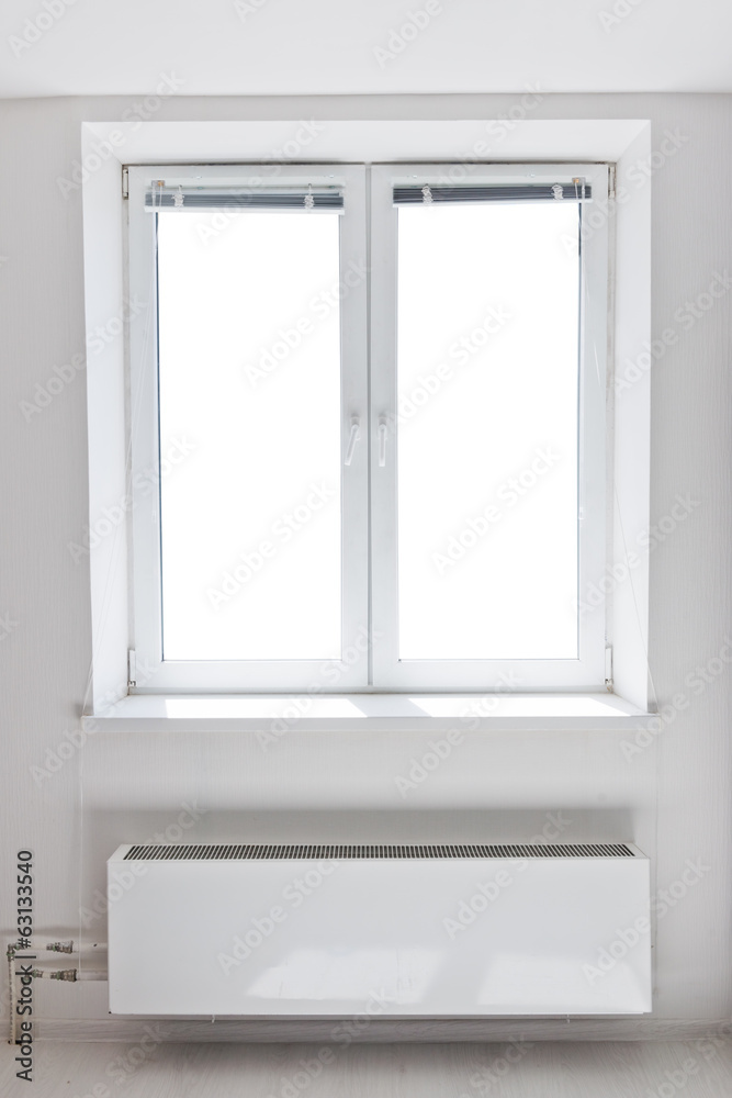 White plastic double door window with radiator under it. White plastic double door window with radiator under it.