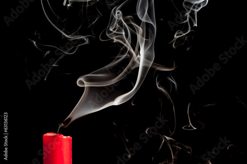 Smoke from blown out red candle