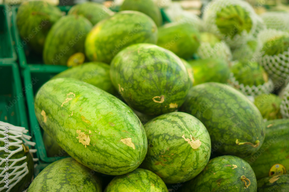 Bunch of watermelons on plastic boxes in store Bunch of watermelons on plastic boxes in store