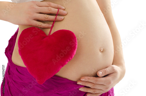 Wallpaper Mural Pregnant belly.Woman expecting a baby girl holding a heart. Torontodigital.ca