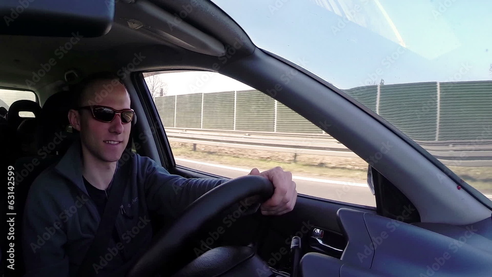 Attractive man smiling during auto trip inside car Attractive man smiling during auto trip inside car