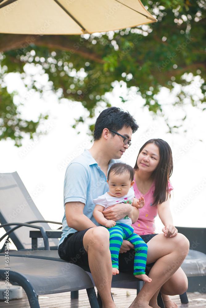 Attractive Asian Family Outdoor Lifestyle on a pool Attractive Asian Family Outdoor Lifestyle on a pool
