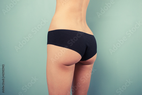 Slender young woman in black underwear © LoloStock