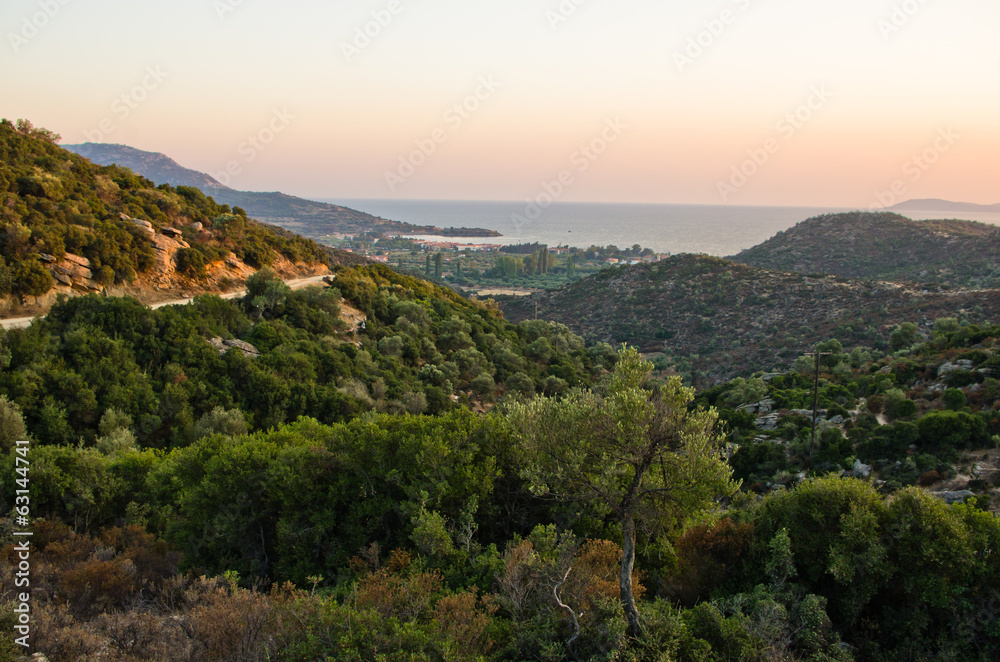 Panorama of a small greek village by the sea at sunset