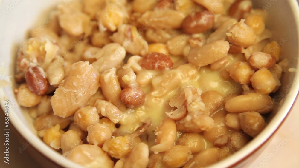 Melt cheese on mix of beans in a pot Melt cheese on mix of beans in a pot