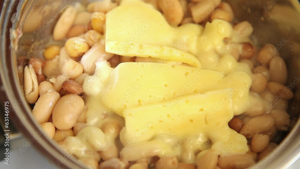 Time lapse of melting cheese on mix of beans in a pot Time lapse of melting cheese on mix of beans in a pot