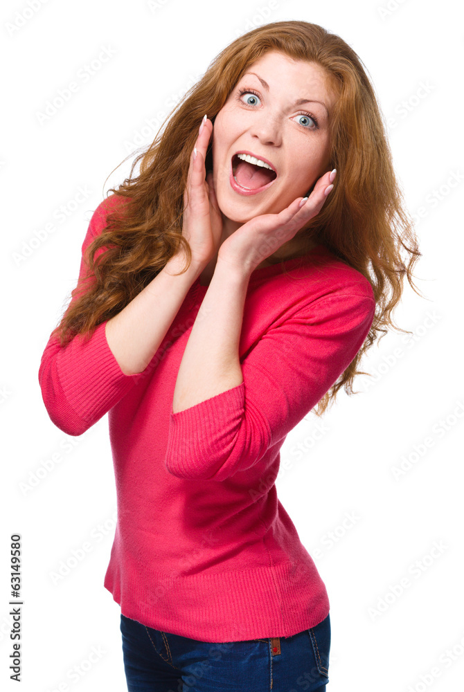 Woman is holding her face in astonishment Woman is holding her face in astonishment
