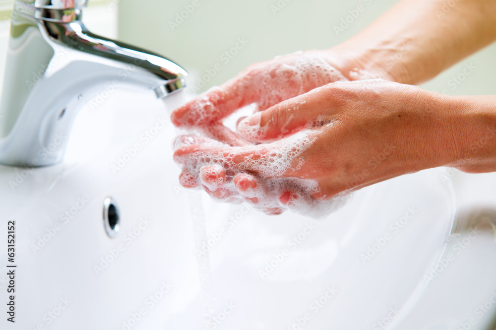 Washing Hands with Soap. Woman Cleaning Hands in a Bathroom Washing Hands with Soap. Woman Cleaning Hands in a Bathroom