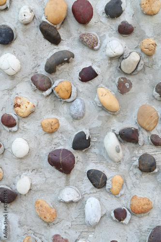 Pebbles in concrete wall texture