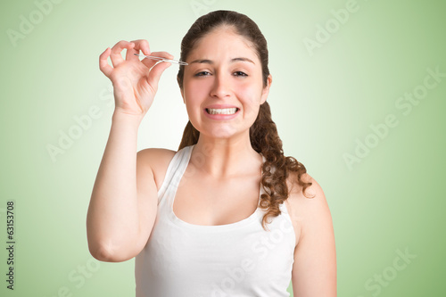 Woman Plucking Eyebrows