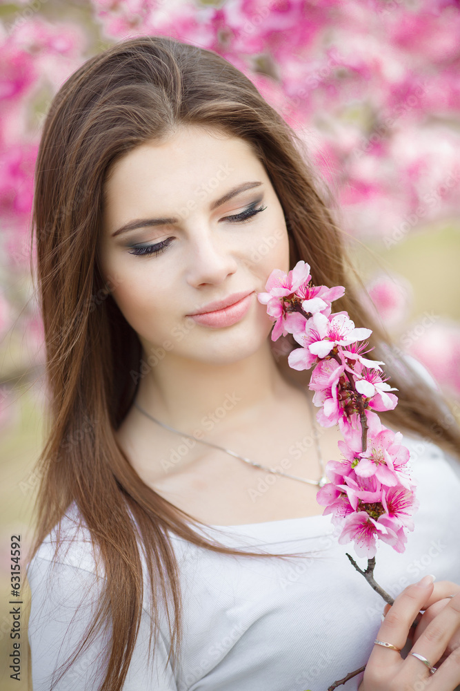 Teenager girl in spring flowers park Teenager girl in spring flowers park