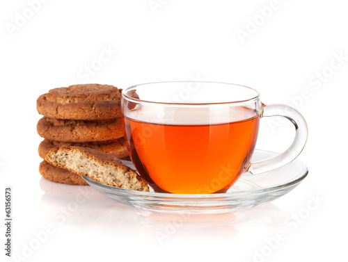 Glass cup of black tea with homemade cookies