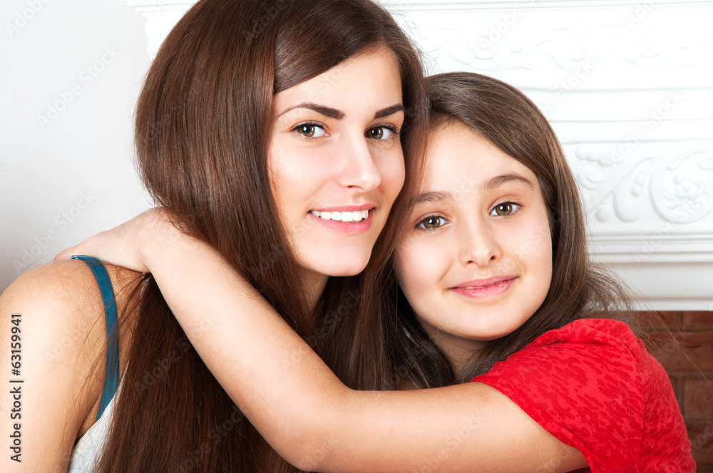 two sisters hug each other two sisters hug each other