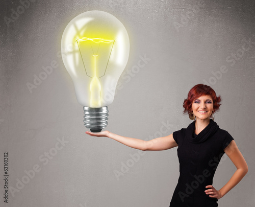 Beautiful lady holding realistic 3d light bulb