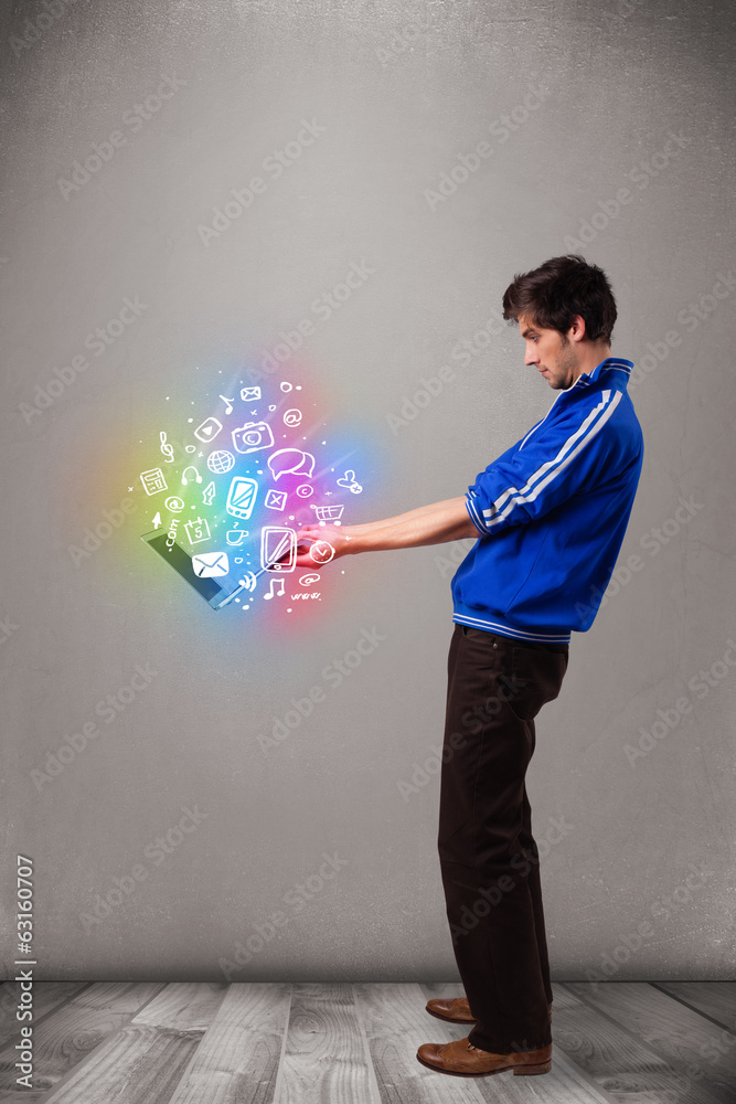 Casual man holding laptop with colorful hand drawn multimedia sy Casual man holding laptop with colorful hand drawn multimedia sy