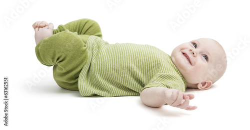 happy toddler lying on his back in green clothing