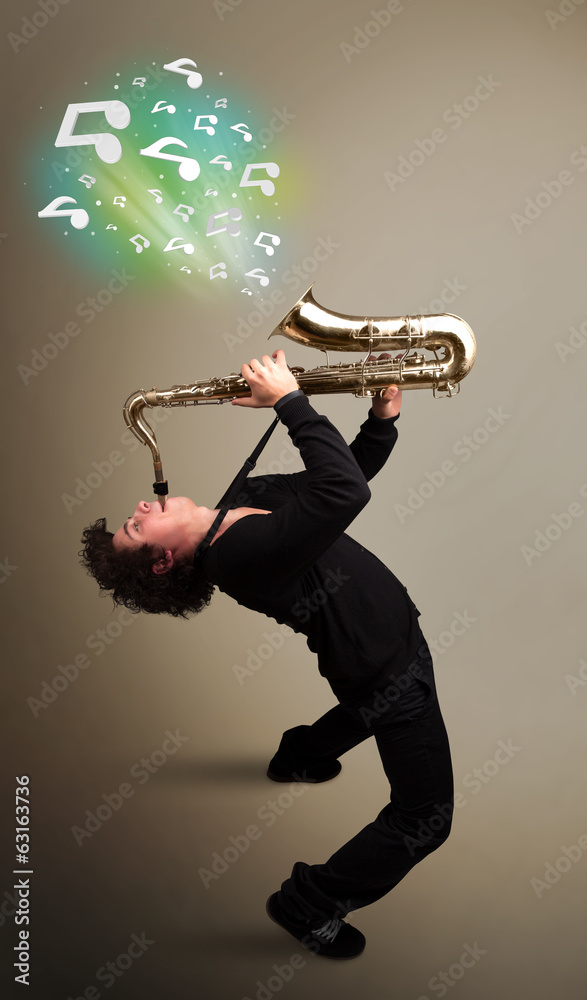 Fototapeta premium Young musician playing on saxophone while musical notes explodin