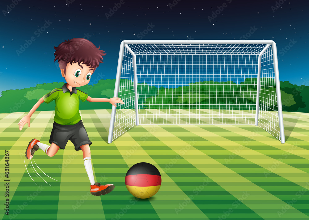 Fototapeta premium A man at the field using the ball with the flag of Germany