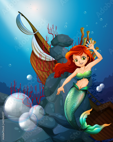 A sea with a mermaid near the wrecked boat