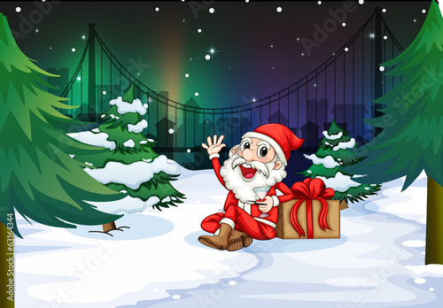 A smiling Santa beside the gift