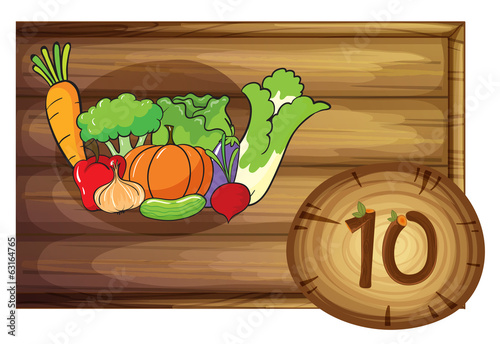 A wooden frame with ten vegetables