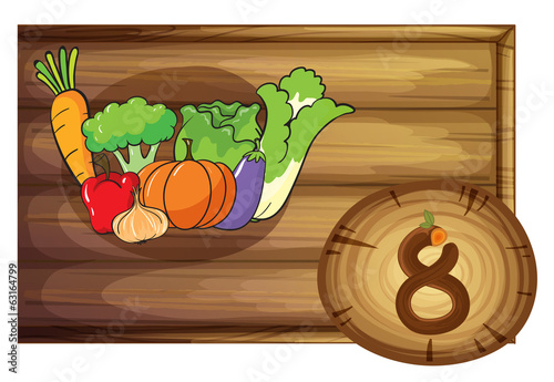 A wooden frame with eight vegetables