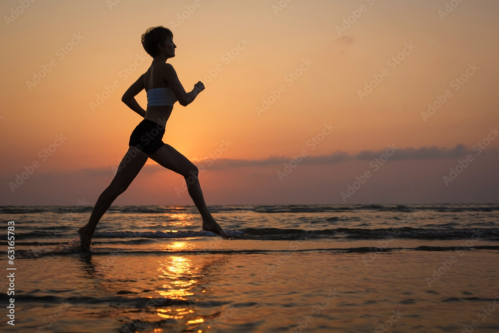 Running exercises on the sea at sunset