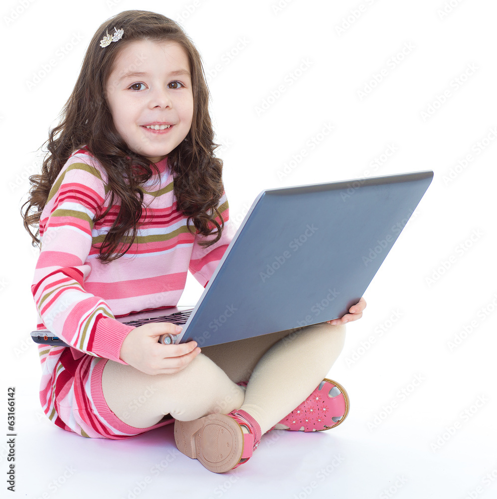 little girl sitting on the floor with a laptop. little girl sitting on the floor with a laptop.