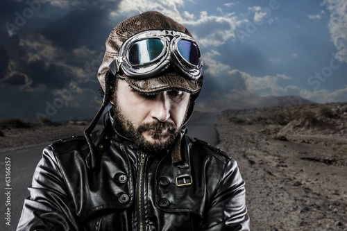 Serious biker with black leather jacket and old glasses © Fernando Cortés