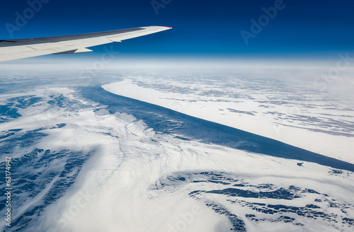 Wing of airplane flying above the Sea of Okhotsk