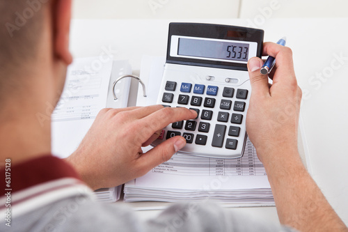Man Calculating Financial Expenses