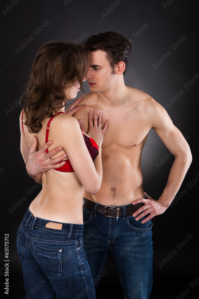 Lusty Couple Standing Over Black Background Lusty Couple Standing Over Black Background