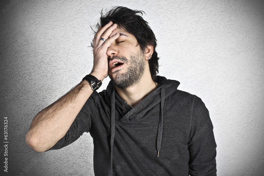Unhappy young man with hand on the head Unhappy young man with hand on the head