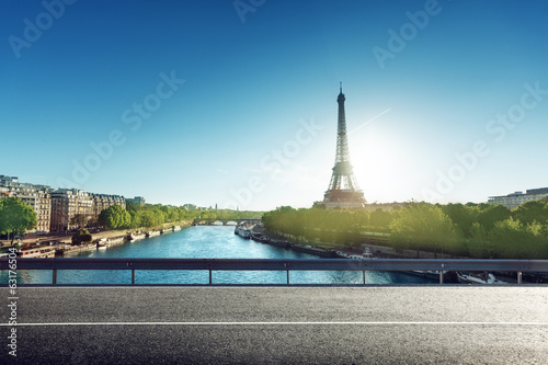 Eiffel Tower and road in sunrise time © Iakov Kalinin